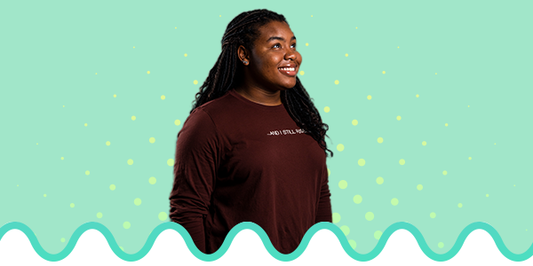 Female student looking up, on top of a green themed gradient background